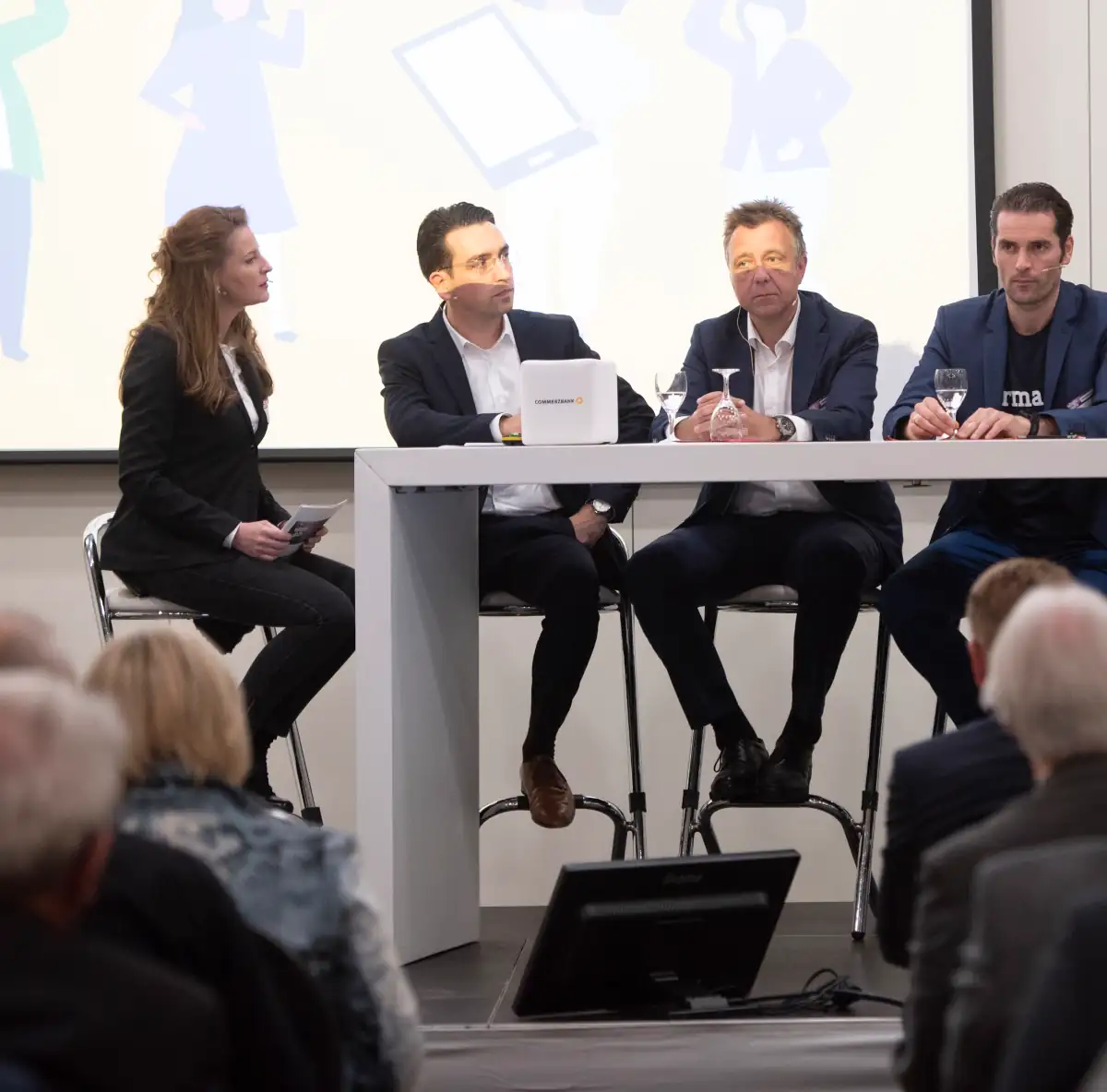 Moderatorin führt eine Podiumsdiskussion mit Panel-Gästen vor Publikum